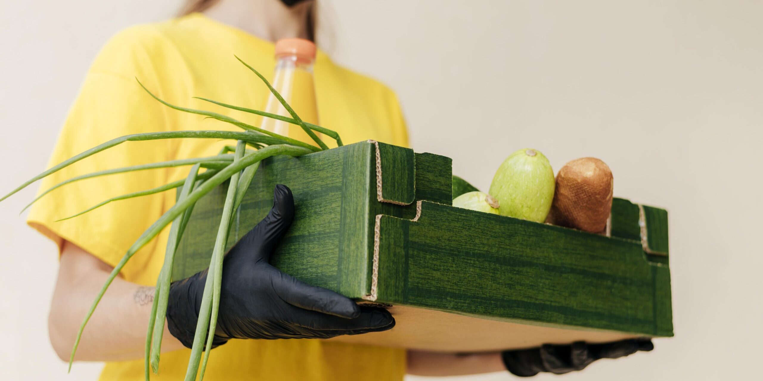 close-up-delivery-woman-holding-food-crate